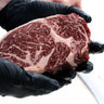Winterfrost American Wagyu Ribeye steak, held to show marbling